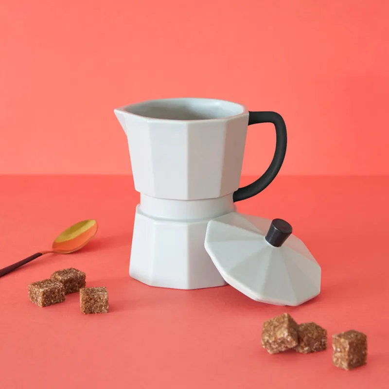 Taza cafetera Moka blanca con granos de café sobre fondo rosa - detalle original para regalar Happyideas