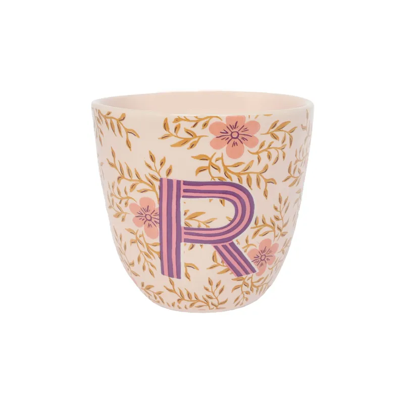 Taza Letra R de cerámica color crema con la letra R en morado y estampado floral, sobre fondo blanco - Happyideas
